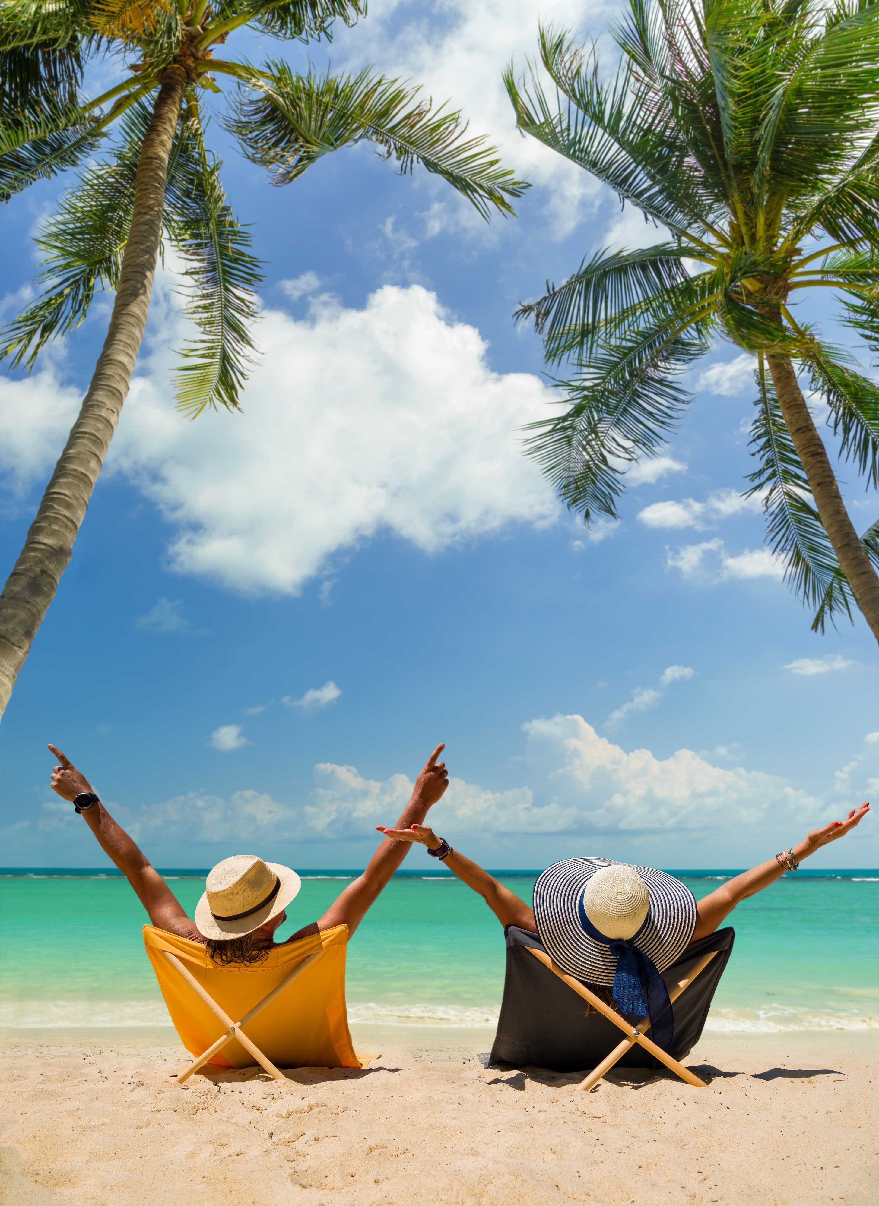 Two travellers at the beach celebrating